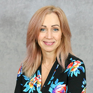 Reliable Impact Team Member Mary Dicken in flower blouse