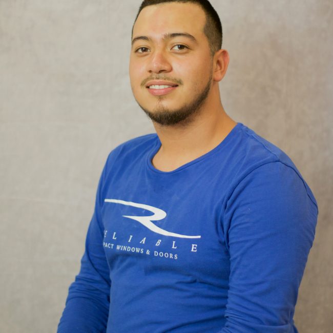 Reliable Impact Team Member Antonio in blue long sleeve shirt