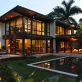 shot of modern south florida home from the backyard featuring large impact windows